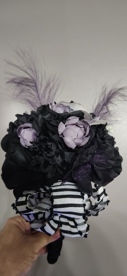 Our Purple Bouquet pairs black blooms with soft lavender roses, wispy purple feathers, and a bold black-and-white striped ribbon bow. It's a hand-wrapped, spooky-chic statement piece that never wilts.